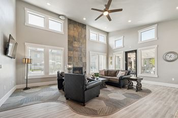 Living room with stone fireplace and large windows